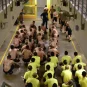 Prisoners sit on the floor of the Changi Prison in Singapore