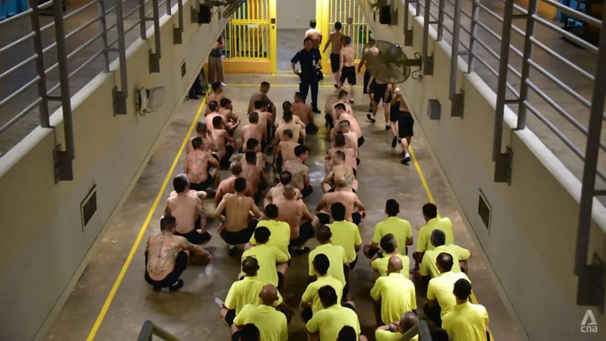 Prisoners sit on the floor of the Changi Prison in Singapore