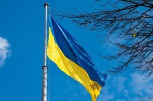The Ukrainian flag flies on a pole in Lviv