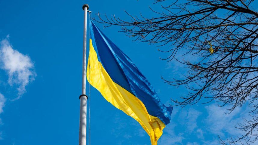 The Ukrainian flag flies on a pole in Lviv