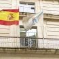 The flags of Spain and the autonomous community of Galicia fly on a balcony