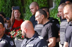 Vassil 'The Skull' Bozhkov is escorted by police after arriving in Bulgaria