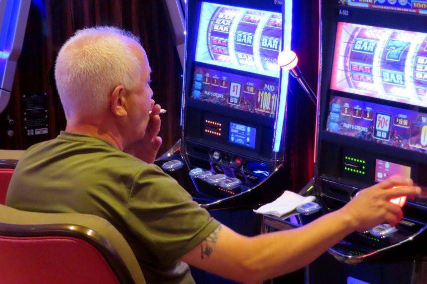 Image of a gambler smoking in a casino