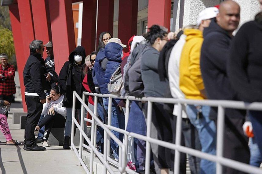 People wait in line for help with unemployment issues