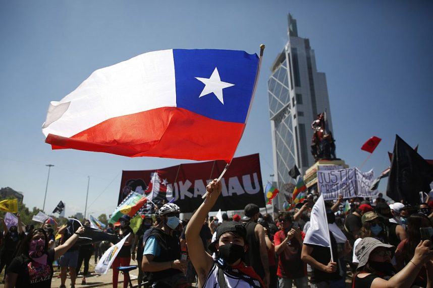 A protester waves a Chilean flag