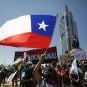 A protester waves a Chilean flag