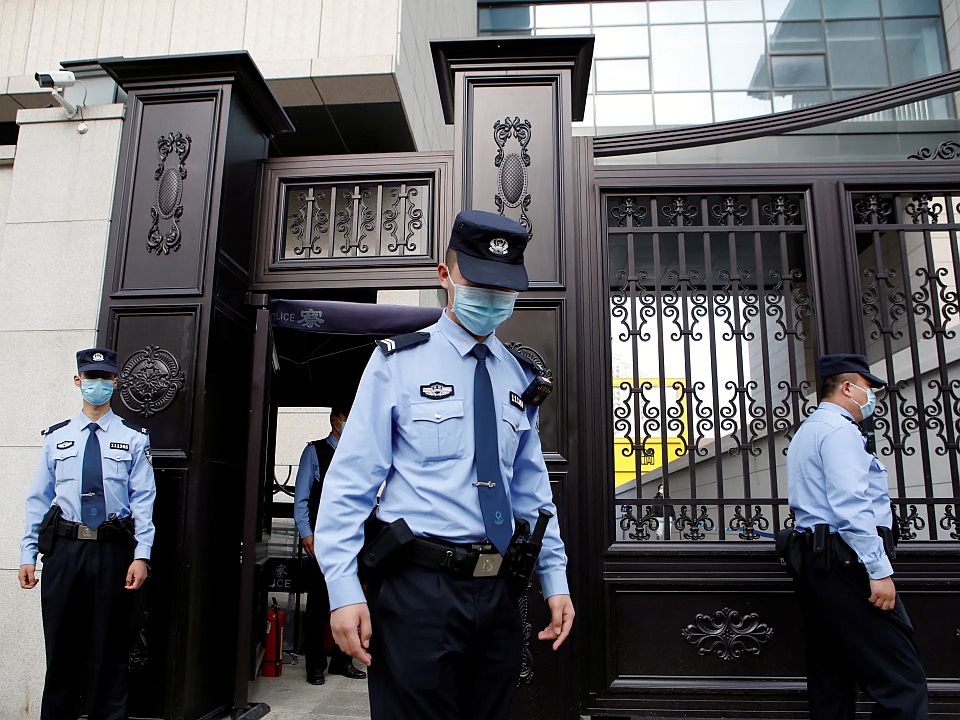 Chinese police stand guard outside a courthouse
