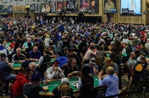 Poker players participate in a packed tournament