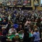 Poker players participate in a packed tournament