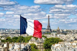 The French flag flies from the Pantheon dome with the Eiffel Tower in the background