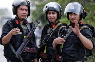 Three armed mobile policemen on patrol in Vietnam