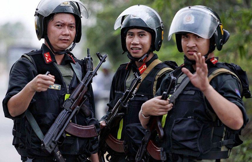 Three armed mobile policemen on patrol in Vietnam