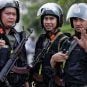 Three armed mobile policemen on patrol in Vietnam