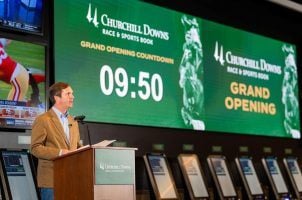 Kentucky Gov. Andy Beshear delivers remarks at Churchill Downs prior to placing the first legal sports bet in the state Sept. 7. The governor has made legal sports betting a key plank in his re-election campaign this year.