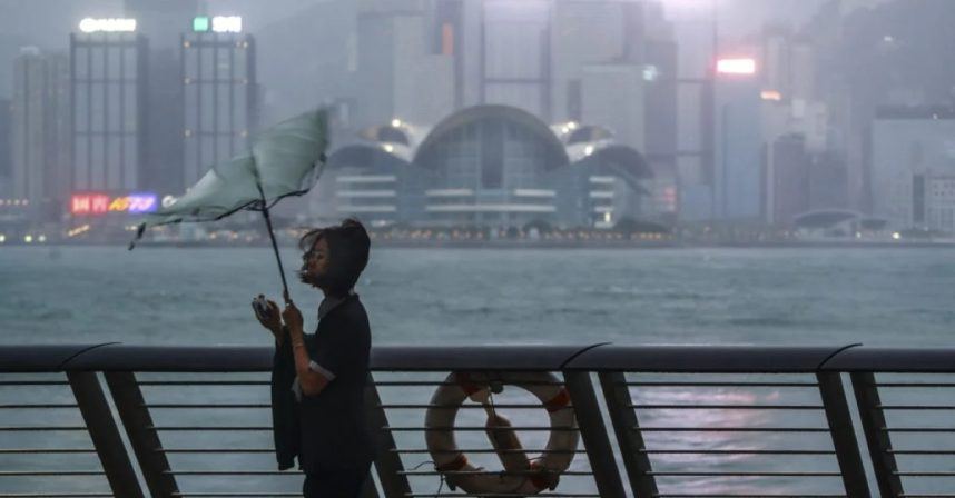 A woman's umbrella in Hong Kong turned inside out by heavy winds