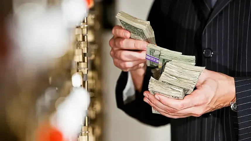 A man holds a stack of money