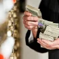 A man holds a stack of money