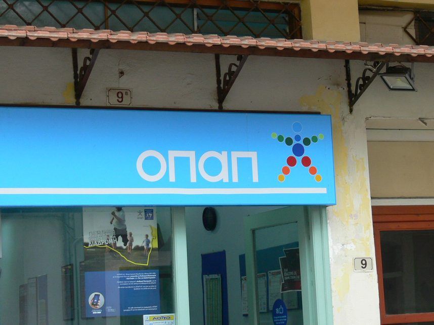A sign displays the OPAP logo on a betting shop in Greece