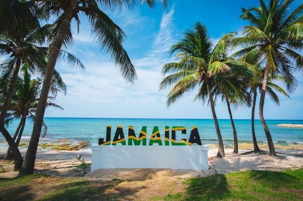 A sign of Jamaica on a beach