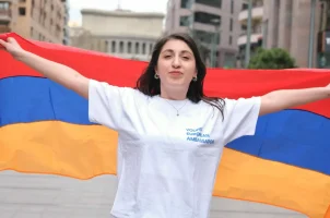A woman holding an Armenian flag