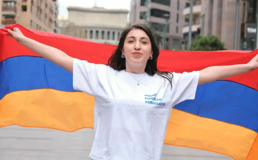 A woman holding an Armenian flag