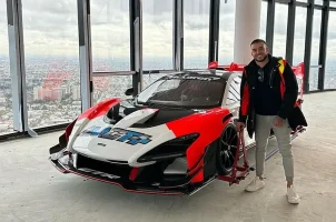 Adrian Portelli shows off the McLaren race car he stores in his Melbourne penthouse