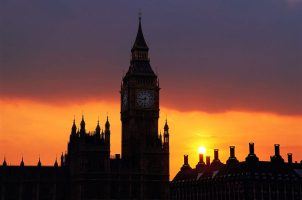 Big Ben stands in front of a fading sun