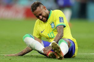 Brazilian soccer player Neymar down on the field with an injury
