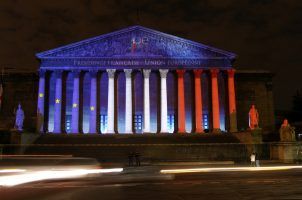 The French National Assembly lit up with the French flag at night