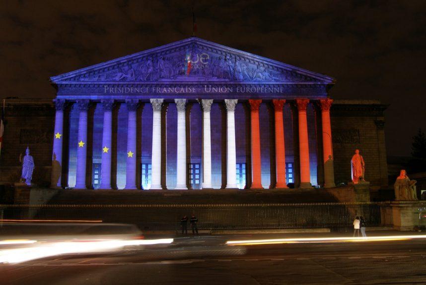 The French National Assembly lit up with the French flag at night