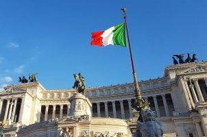 The Italian flag flying in front of the Monument to Vittorio Emanuele II in Rome, Italy