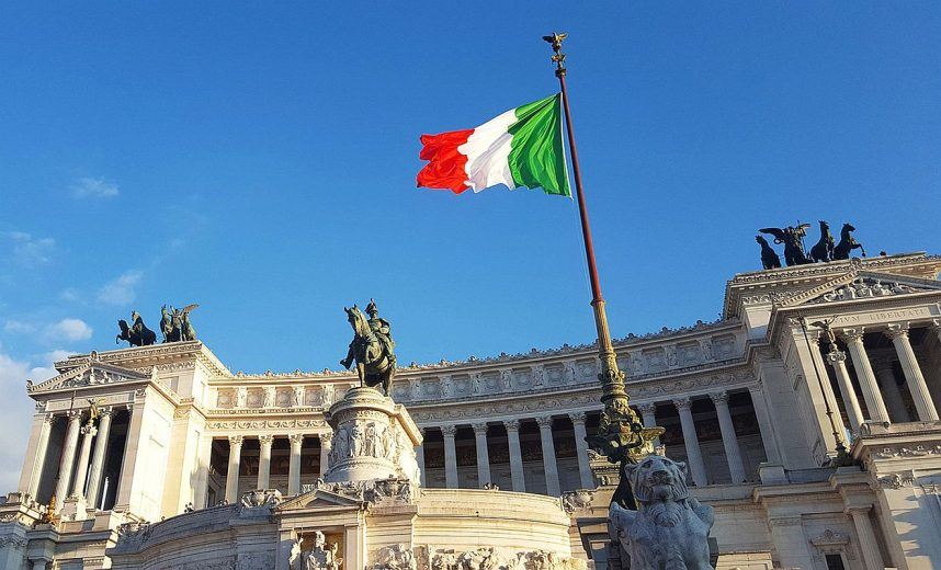 The Italian flag flying in front of the Monument to Vittorio Emanuele II in Rome, Italy
