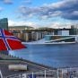 The Norwegian flag flying in front of the Oslo Opera House