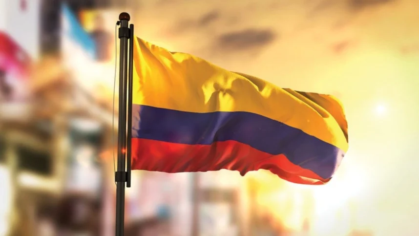 The flag of Colombia against a backdrop of the sun