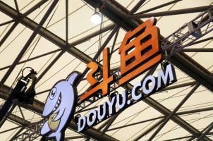 A sign for Chinese streaming platform DouYu installed in a stadium