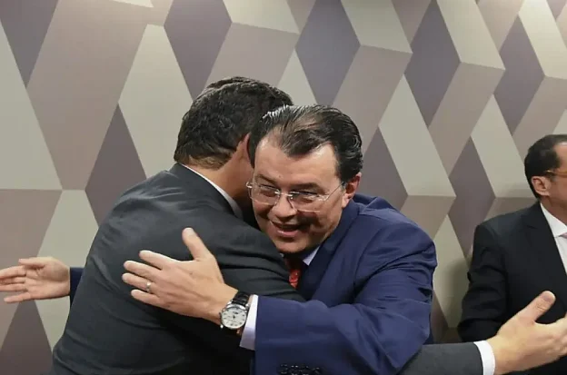 Brazilian Senator Eduardo Braga and another senator celebrate legislative efforts