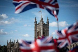 British flags fly in front of the Palace of Westminster