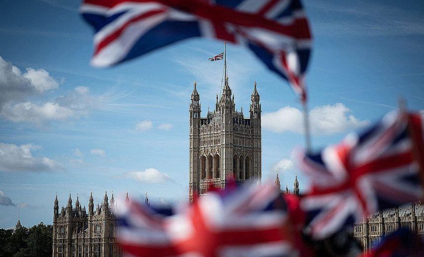British flags fly in front of the Palace of Westminster
