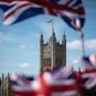 British flags fly in front of the Palace of Westminster