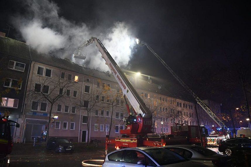 Firefighters work to extinguish a fire in Dortmund, Germany