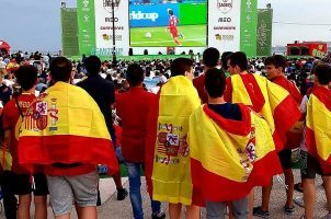 Spaniards wearing flags while watching Spain in the World Cup