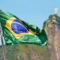 The Brazilian flag flying against a background of the Christ the Redeemer statue