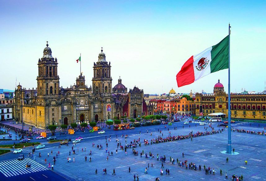 The Mexican flag flies over the Zocalo, or Constitution Square, in Mexico City