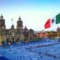 The Mexican flag flies over the Zocalo, or Constitution Square, in Mexico City