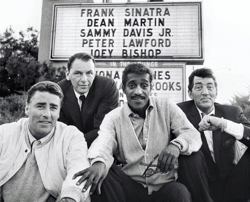 Peter Lawford, Frank Sinatra, Sammy Davis Jr., and Dean Martin pose in front of the Sands