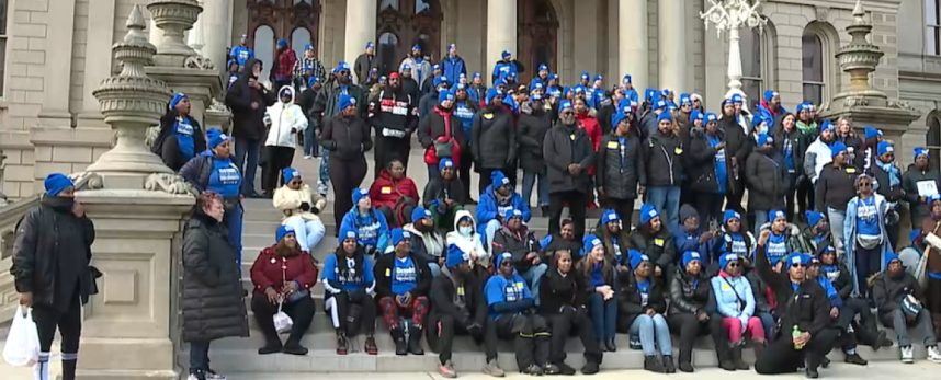 Casino workers on the steps of the Michigan state capitol 