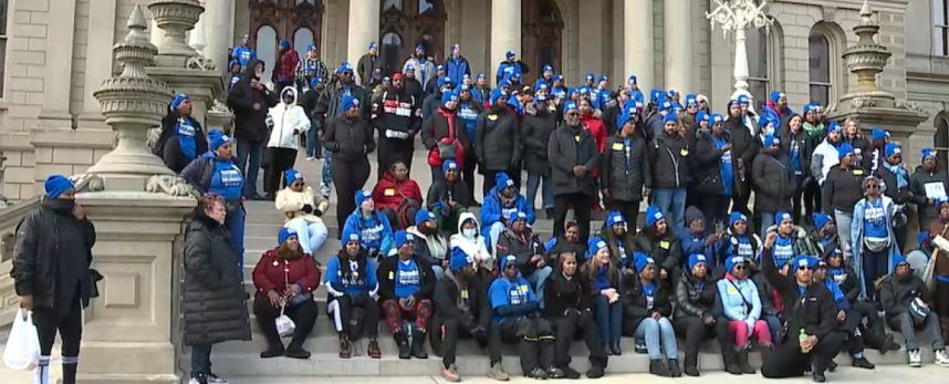 Casino workers on the steps of the Michigan state capitol