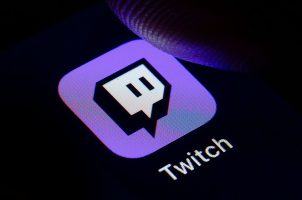 A man pressing the Twitch icon on his cell phone