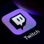 A man pressing the Twitch icon on his cell phone