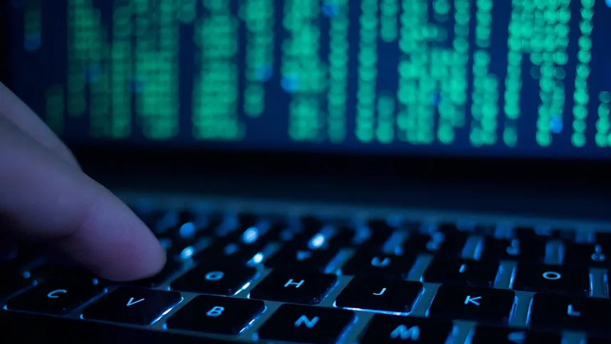 A man typing on a laptop keyboard